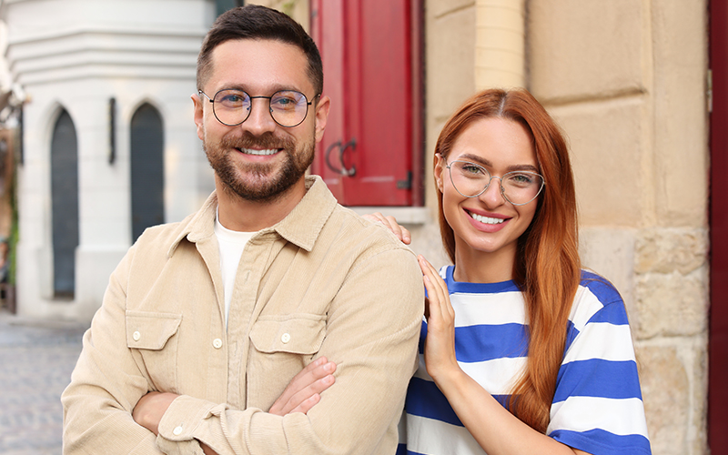 A man and a woman posing for a photo together, with the man standing to the left of the woman.